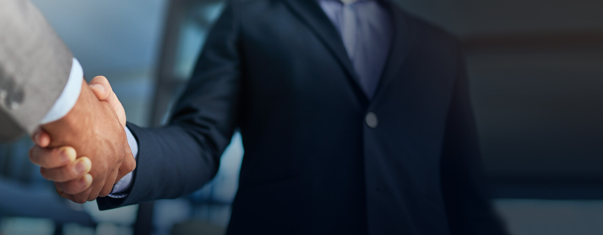 two men shake hands closeup